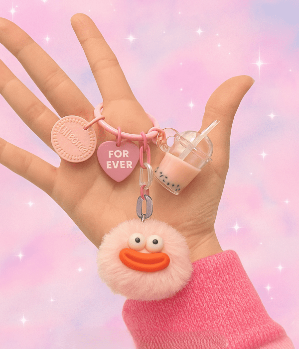 Puffy Collection keychain with plush character and surprise charm in pastel color, cute accessory on soft pink background