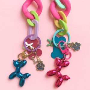 Cute balloon keychain with pastel silicone bracelet, glittery charms, and a soft pink background — part of the Happy Collection by Pasha Love.